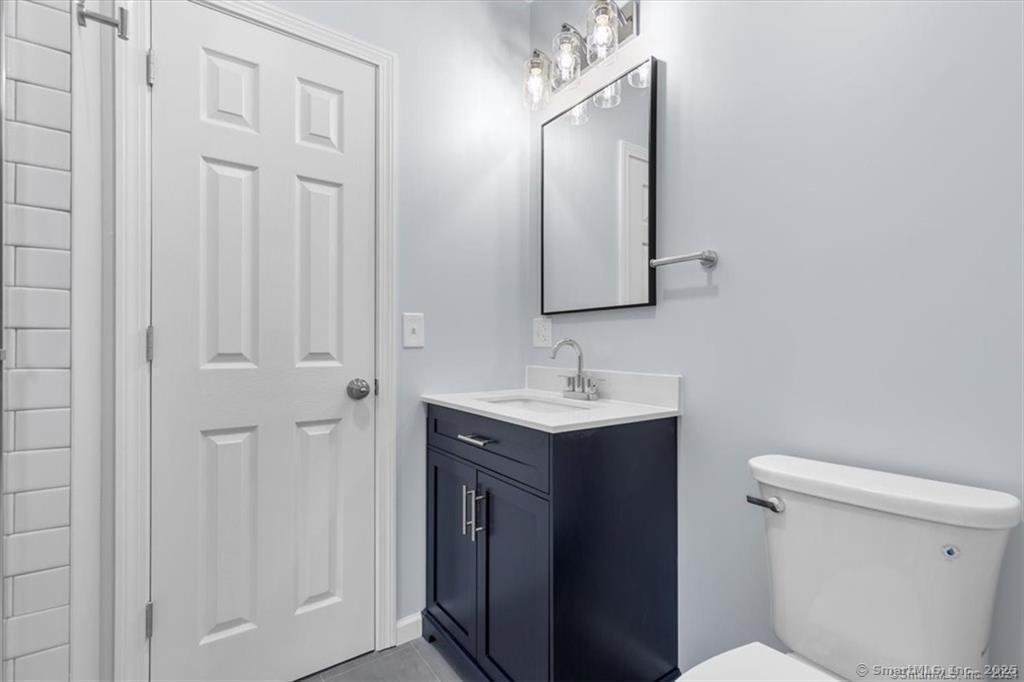 55 Admiral Street, Unit 2 New Haven, CT 06511 - Photo 14 of 35 a bathroom with a toilet sink and mirror