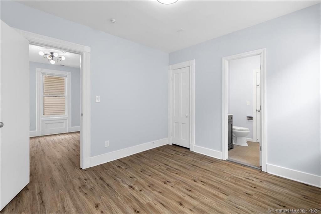 55 Admiral Street, Unit 2 New Haven, CT 06511 - Photo 16 of 35 a view of an empty room with wooden floor and a bathroom