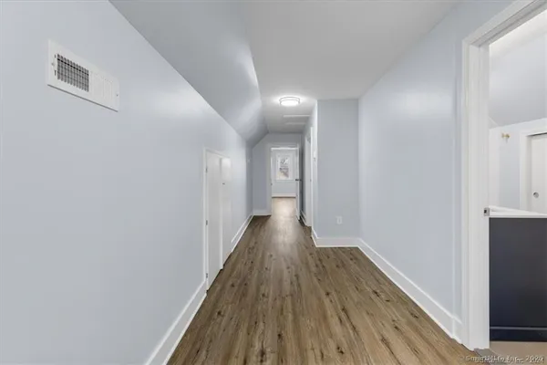 a view of gallery with wooden floor