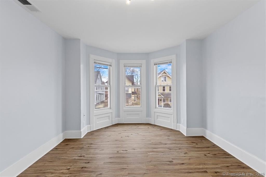 55 Admiral Street, Unit 2 New Haven, CT 06511 - Photo 2 of 35 an empty room with wooden floor and window