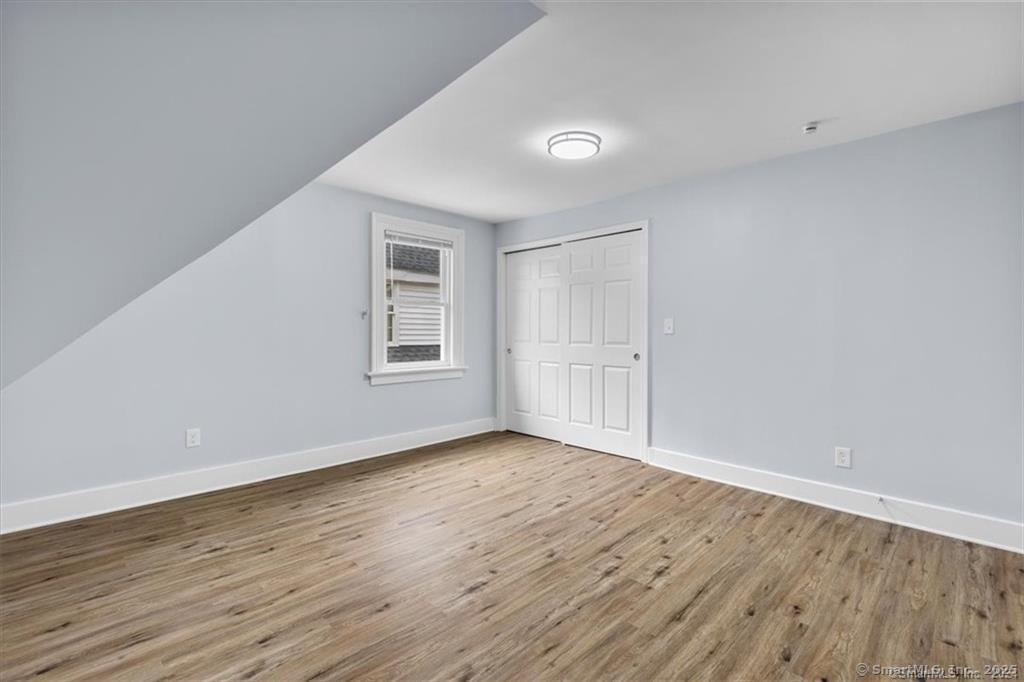 55 Admiral Street, Unit 2 New Haven, CT 06511 - Photo 26 of 35 an empty room with wooden floor and windows