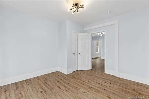 a view of an empty room with wooden floor