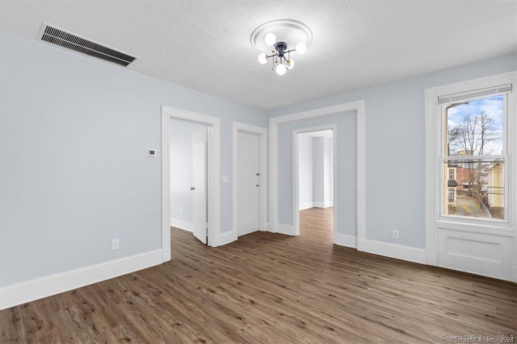 55 Admiral Street, Unit 2 New Haven, CT 06511 - Photo 4 of 35 a view of empty room with wooden floor and window