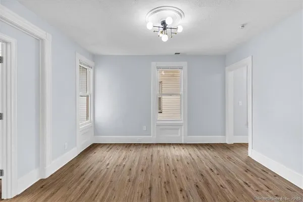 wooden floor in an empty room with a window
