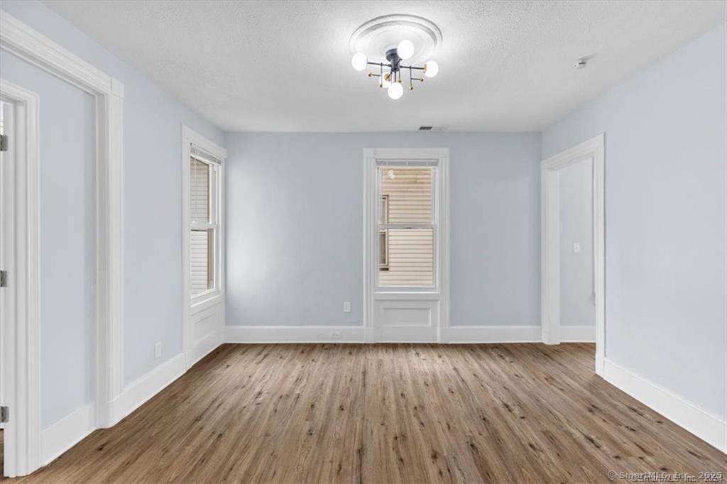 55 Admiral Street, Unit 2 New Haven, CT 06511 - Photo 5 of 35 wooden floor in an empty room with a window