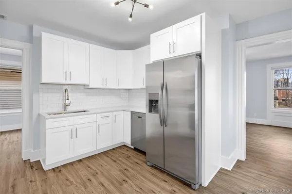 a kitchen with stainless steel appliances granite countertop a refrigerator and a stove top oven