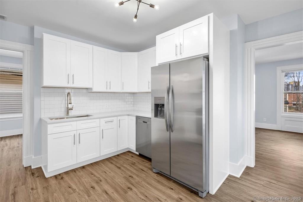 55 Admiral Street, Unit 2 New Haven, CT 06511 - Photo 9 of 35 a kitchen with stainless steel appliances granite countertop a refrigerator and a stove top oven