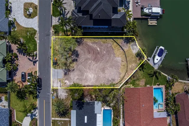 an aerial view of a house with a yard and lake view