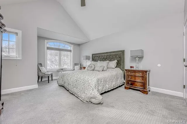 a bedroom with a bed and a window with lamp