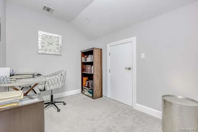 a view of a workspace with furniture