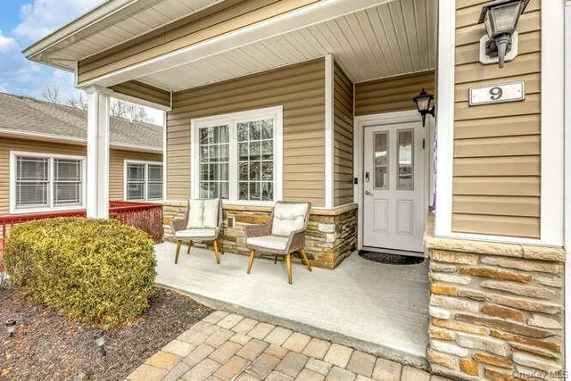 a backyard of a house with outdoor seating