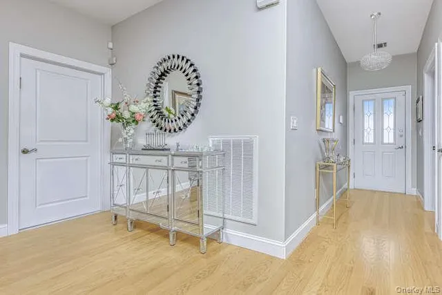 a view of a bedroom with wooden floor and entryway