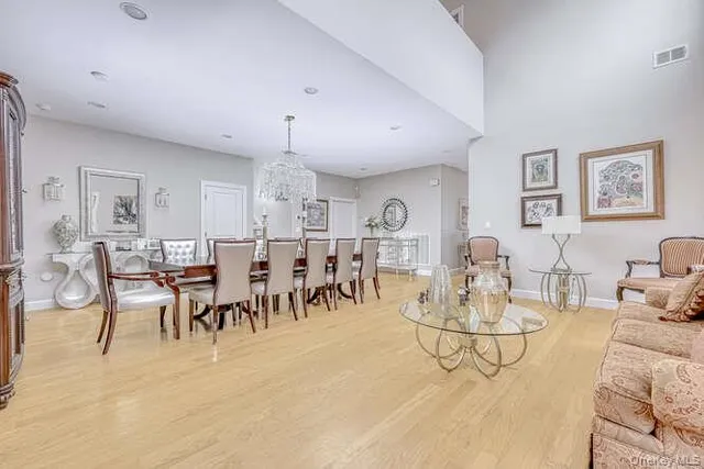 a living room with lots of furniture and view of kitchen