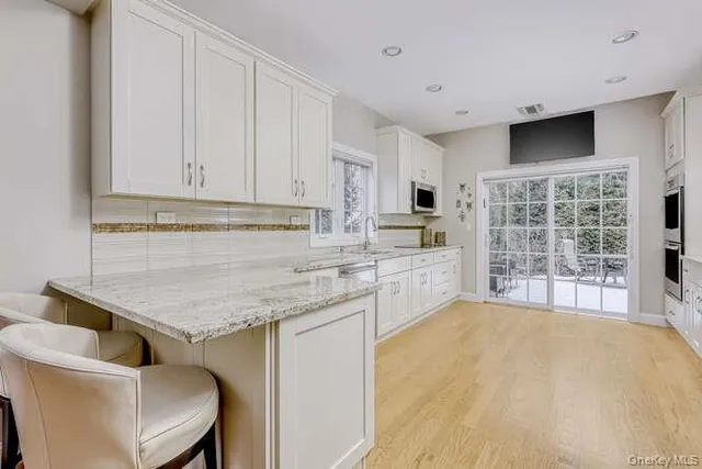 a kitchen with a stove a sink and a refrigerator