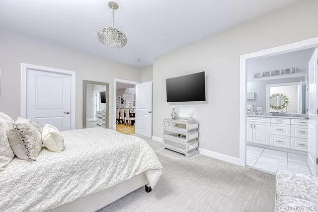 a bedroom with furniture and flat screen tv