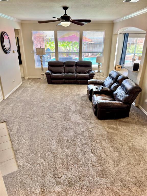 2016 Postwood Court Corinth, TX 76210 - Photo 11 of 39 a living room with furniture and a flat screen tv