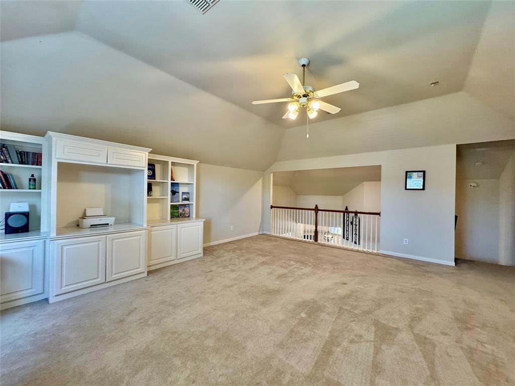 2016 Postwood Court Corinth, TX 76210 - Photo 20 of 39 a view of a kitchen with cabinet and a ceiling fan