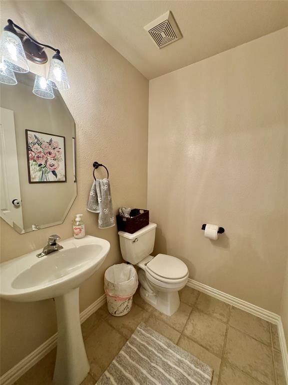 2016 Postwood Court Corinth, TX 76210 - Photo 21 of 39 a bathroom with a toilet sink and mirror