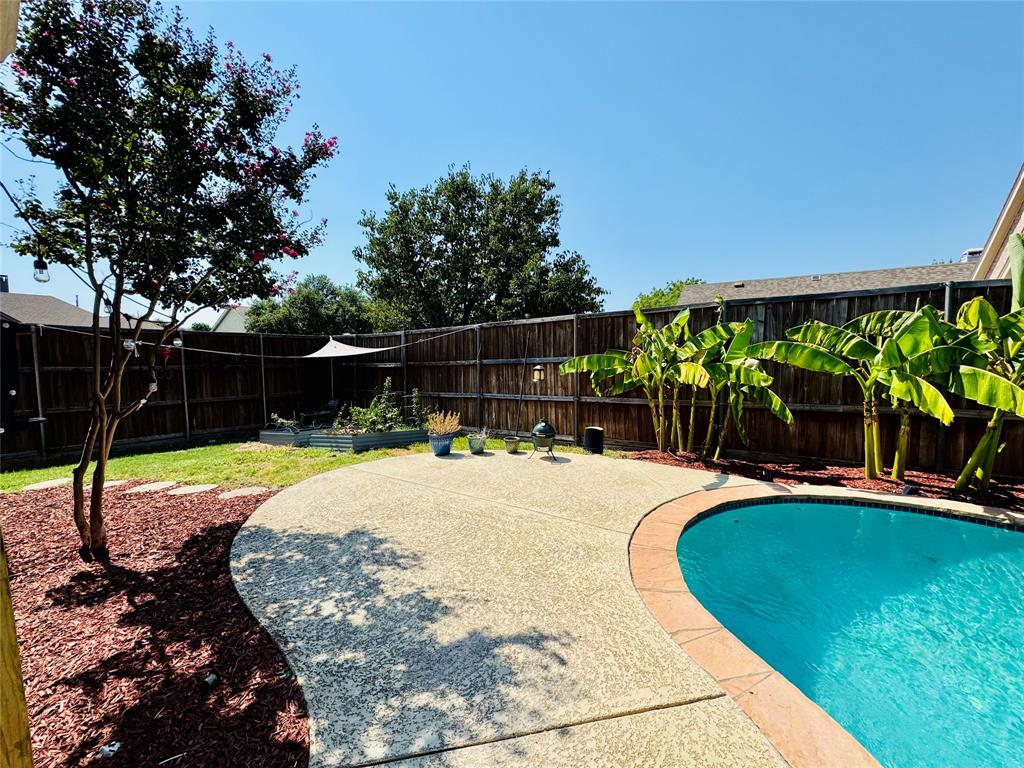 2016 Postwood Court Corinth, TX 76210 - Photo 25 of 39 a view of a swimming pool with a patio and plants