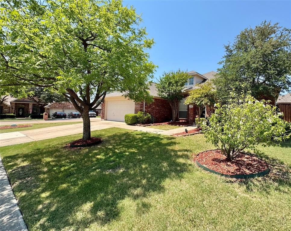 2016 Postwood Court Corinth, TX 76210 - Photo 27 of 39 a view of a garden with a tree