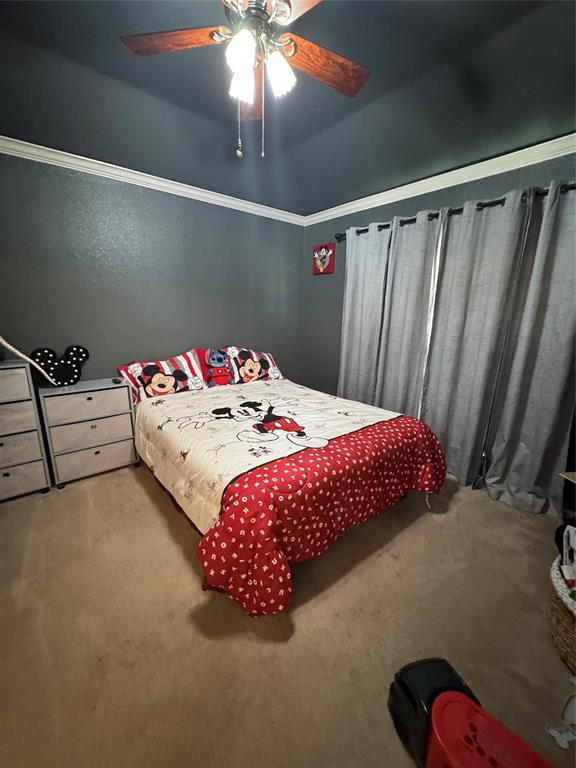 2016 Postwood Court Corinth, TX 76210 - Photo 31 of 39 a bedroom with a bed and a chandelier