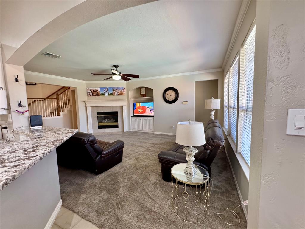 2016 Postwood Court Corinth, TX 76210 - Photo 10 of 39 a living room with furniture and a fireplace