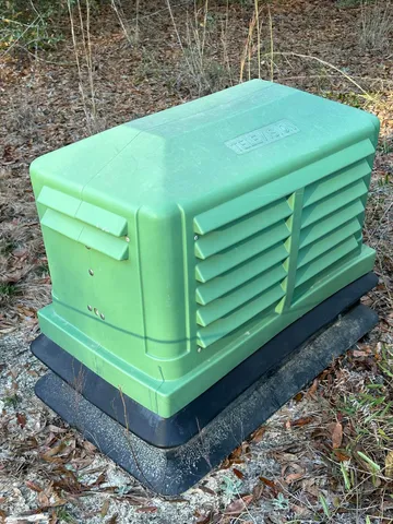 a green field with some trees in the background