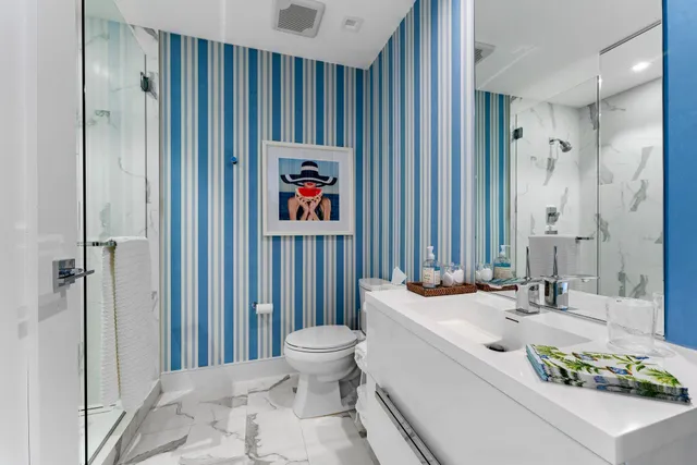 a bathroom with a sink toilet and shower