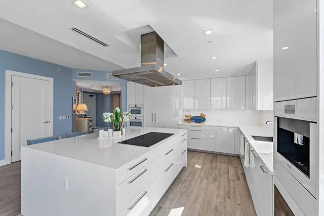 a kitchen with white cabinets and white appliances
