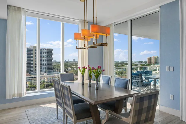 a dining room with furniture a chandelier and wooden floor