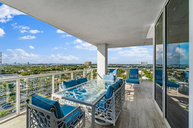 a view of a balcony with chairs and wooden floor