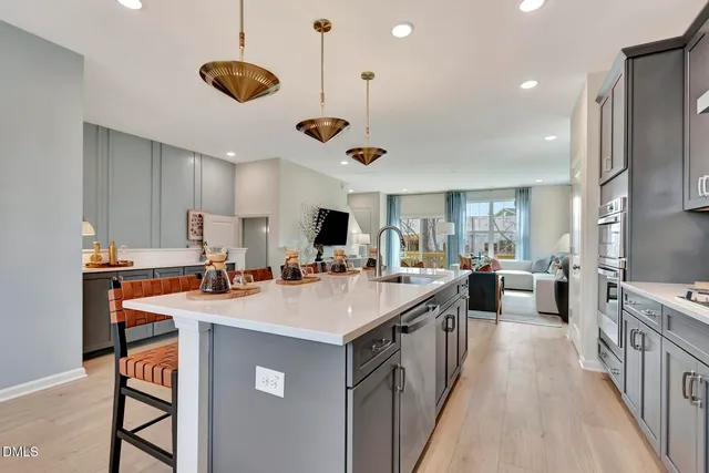 a living room with furniture and kitchen view