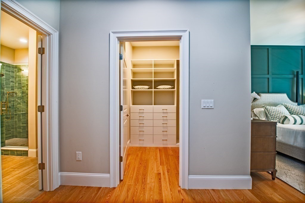20 B Legacy Lane Groton, MA 01450 - Photo 6 of 11 hallway with view of wooden floor and cabinet