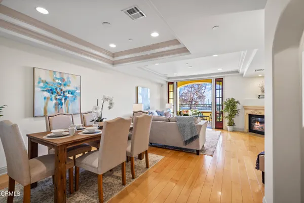 a dining room with furniture a rug and wooden floor