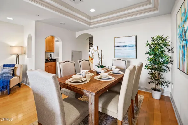 a view of a dining room with furniture and wooden floor
