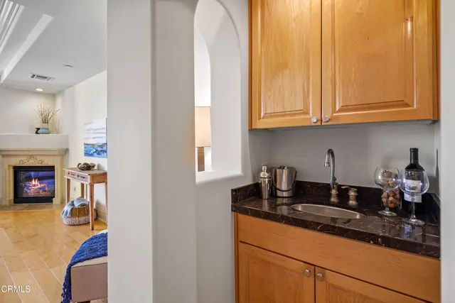 a living room with furniture and a dining table with wooden floor