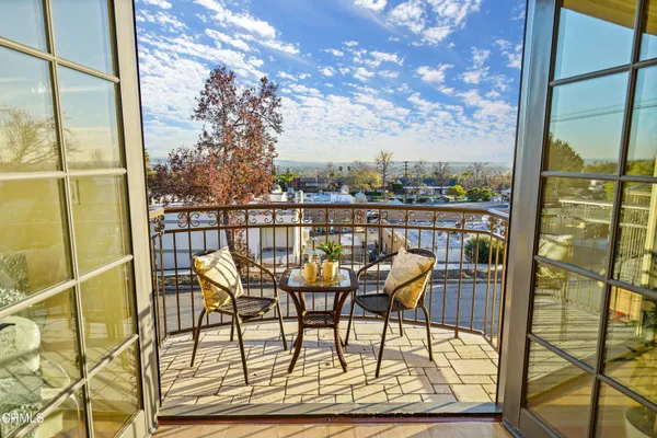 a view of a chairs and table in balcony
