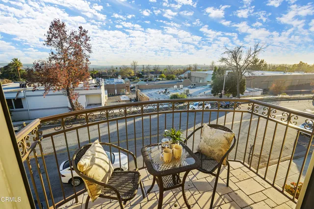 a view of a chairs and table in the balcony
