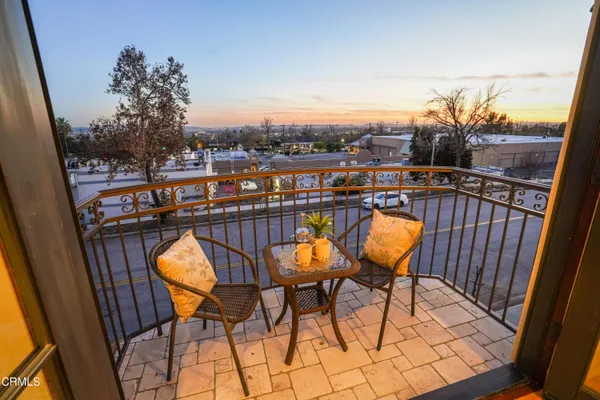 a view of a balcony with furniture and wooden floor