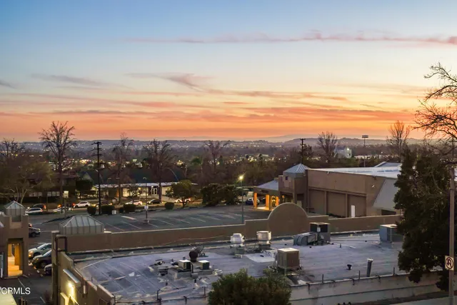a bathroom with a granite countertop sink a toilet a mirror and shower