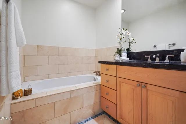 a bathroom with a granite countertop sink a toilet and shower