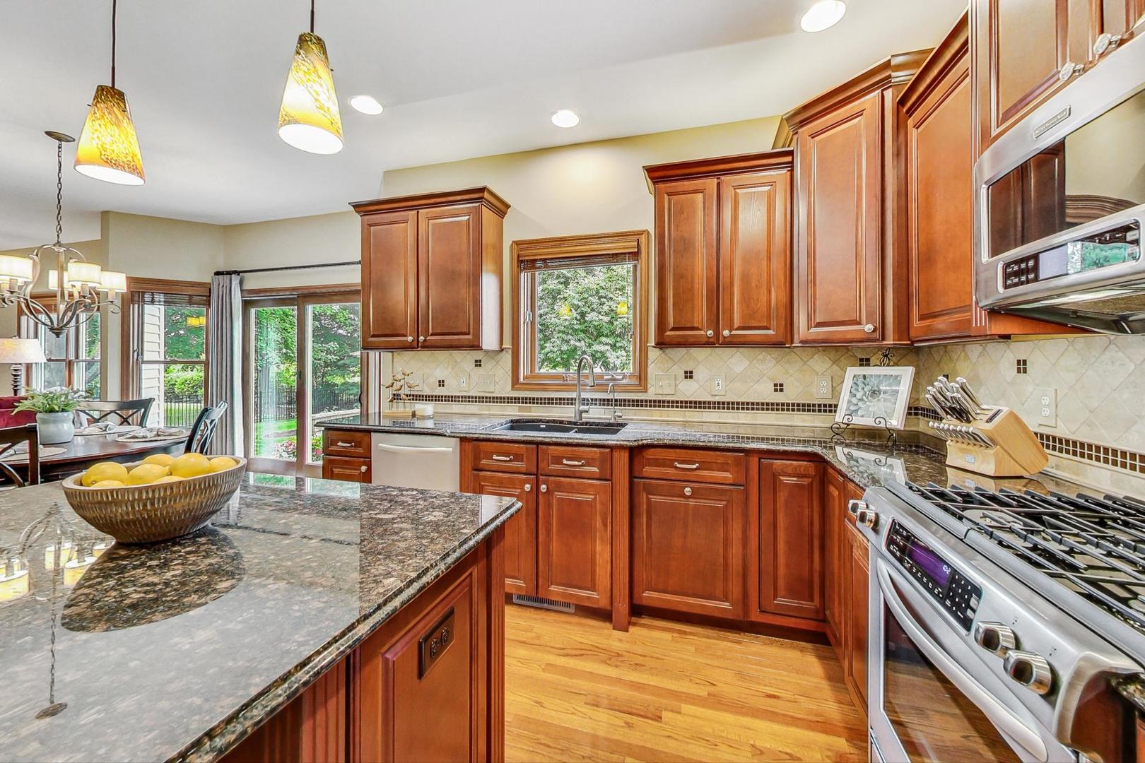 S548 Grengs Lane Geneva, IL 60134 - Photo 11 of 49 a kitchen with a sink stove and cabinets