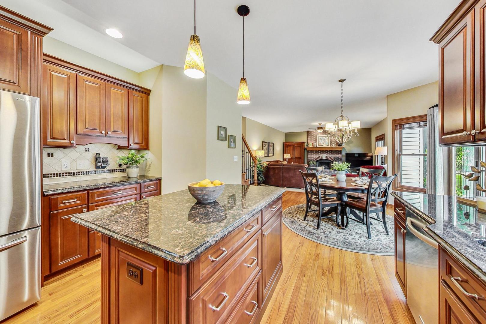 S548 Grengs Lane Geneva, IL 60134 - Photo 12 of 49 a kitchen with a table chairs and microwave