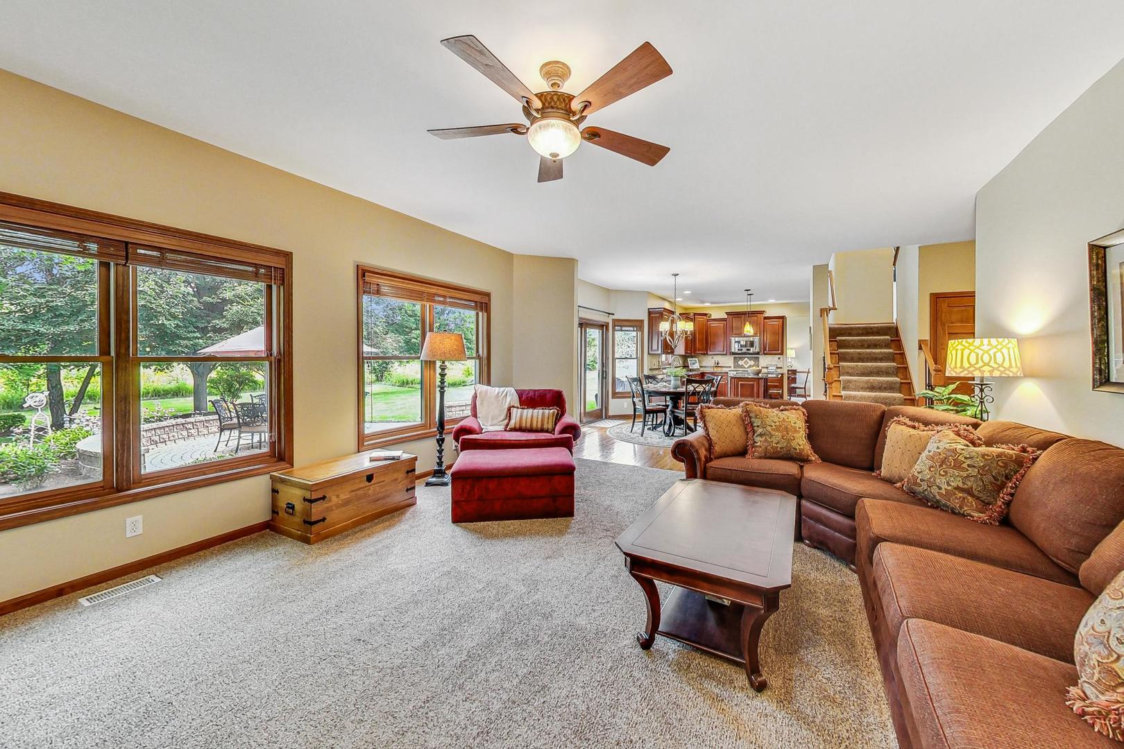 S548 Grengs Lane Geneva, IL 60134 - Photo 17 of 49 a living room with furniture and a large window with wooden floor