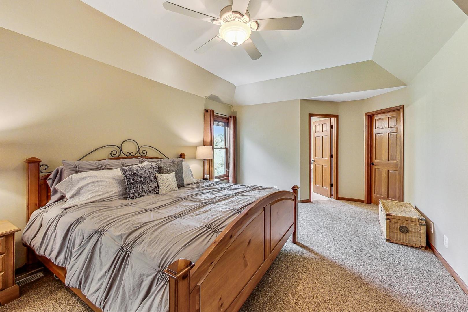 S548 Grengs Lane Geneva, IL 60134 - Photo 19 of 49 a bedroom with a bed and a chandelier