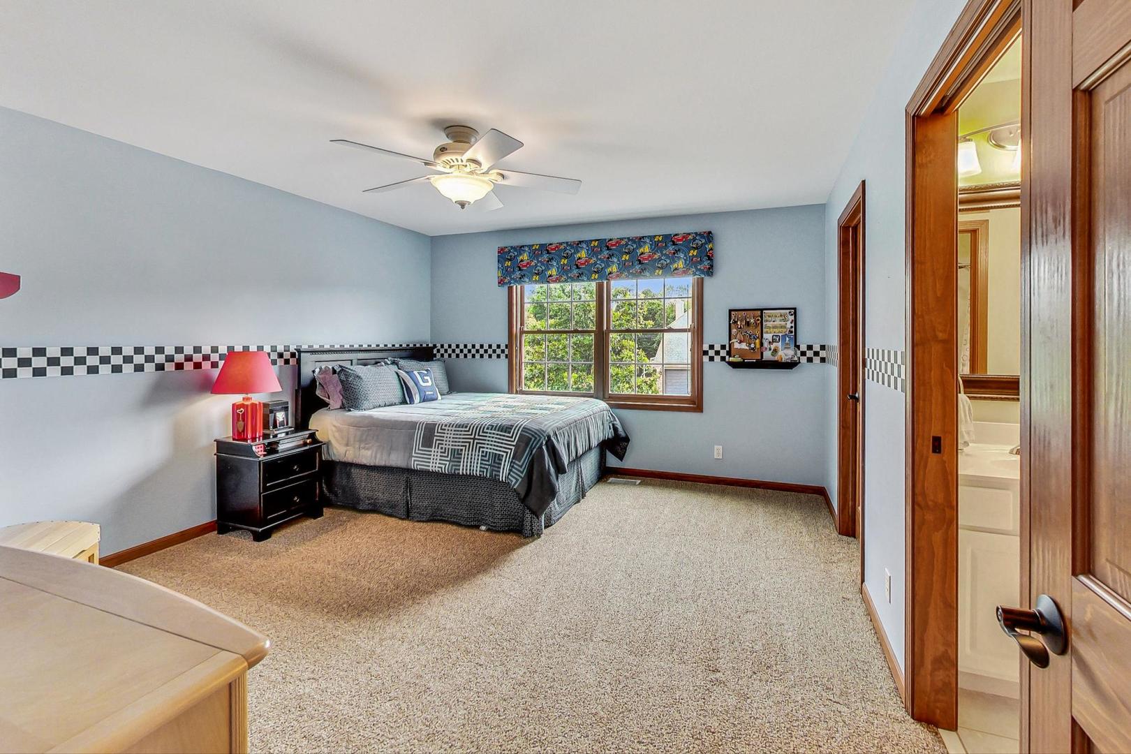 S548 Grengs Lane Geneva, IL 60134 - Photo 24 of 49 a bedroom with a bed and a large window