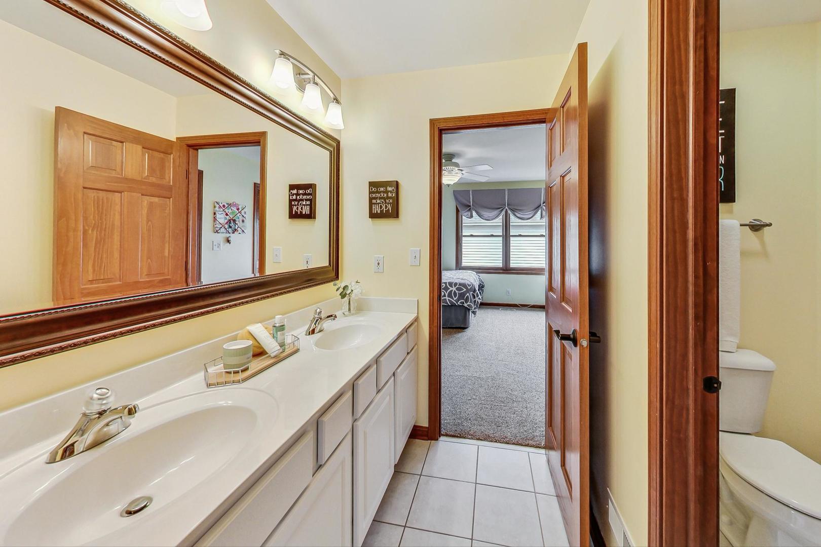 S548 Grengs Lane Geneva, IL 60134 - Photo 25 of 49 a bathroom with a double vanity sink and mirror