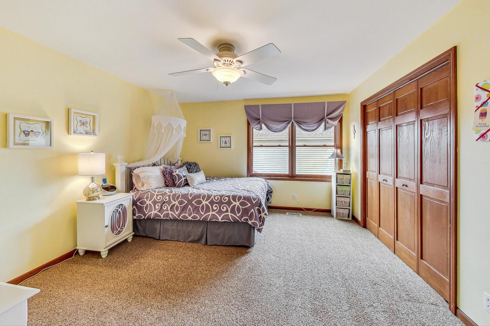 S548 Grengs Lane Geneva, IL 60134 - Photo 27 of 49 a bedroom with a bed and a chandelier