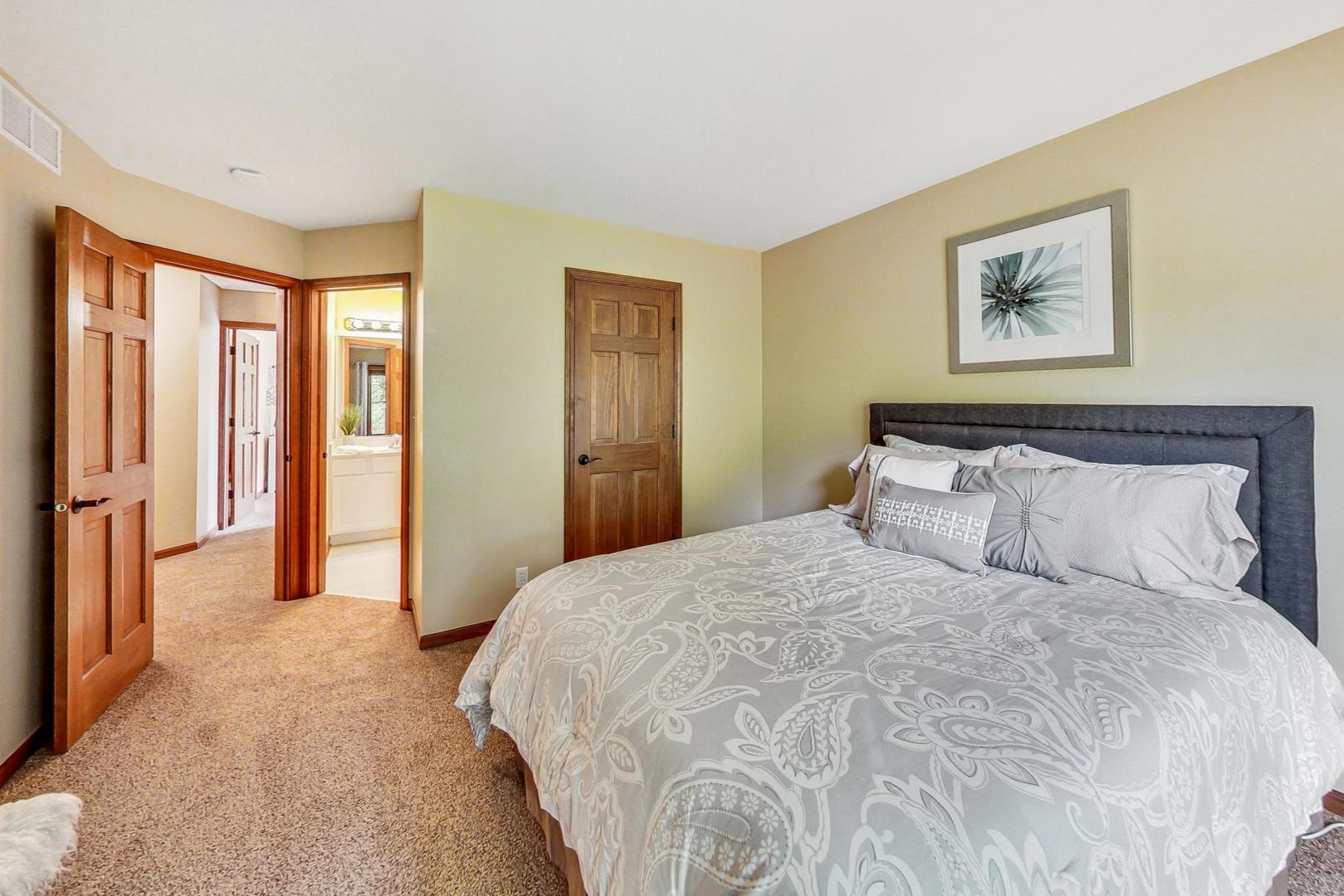 S548 Grengs Lane Geneva, IL 60134 - Photo 29 of 49 a bedroom with a large bed and a window