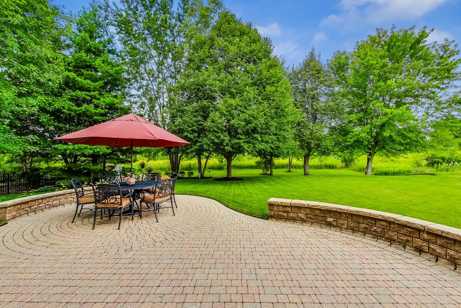 S548 Grengs Lane Geneva, IL 60134 - Photo 43 of 49 a view of a yard with a table and chairs under an umbrella